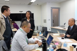 Louie A. Belleza (L) of the Embassy of the Republic of the Philippines in Japan speaking with Filipino mission members while attending day 5 sessions as an observer.