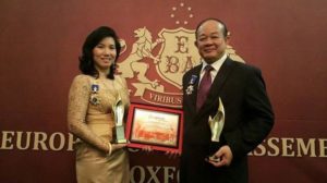 Keo Mom receiving an award for being the best enterprise in food manufacturing in Cambodia in London, 2015.